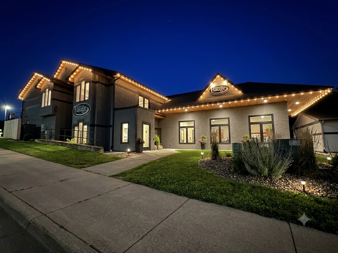 Dental clinic office building with permanent warm-white roofline lighting at dusk