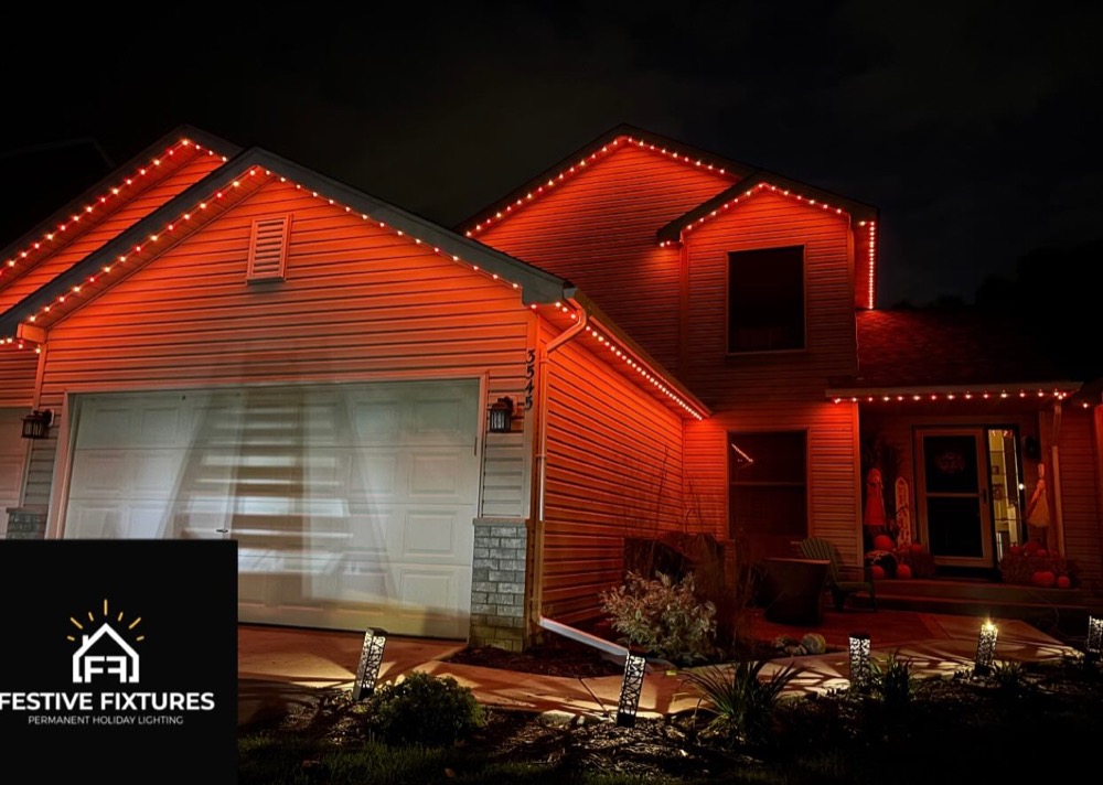 Home with amber permanent architectural lighting for Halloween
